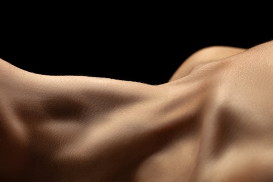 beautiful female slim neck with clavicle on black background