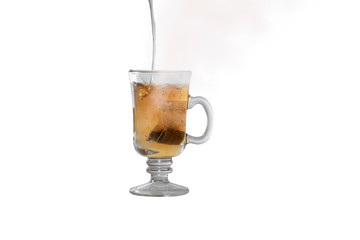 Pouring water into cup of black tea