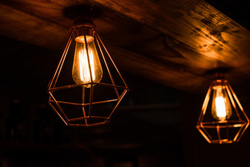 Vintage antique hanging light bulbs at a street food market. Holidays and business good idea concept.