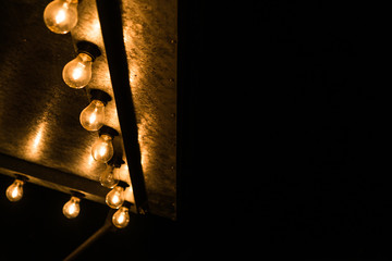 Vintage antique hanging light bulbs at a street food market. Holidays and business good idea...