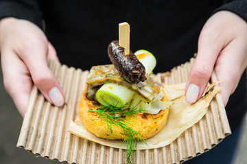 Close up photo of gourmet arepa, traditional Colombian corn patties, with blood sausage, head...