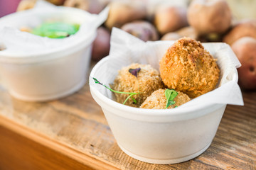 Close up photo of croquette cake at a street food market fair festival
