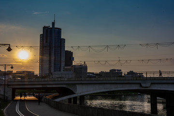 Skyscraper overlooking the city and bridge at sunset