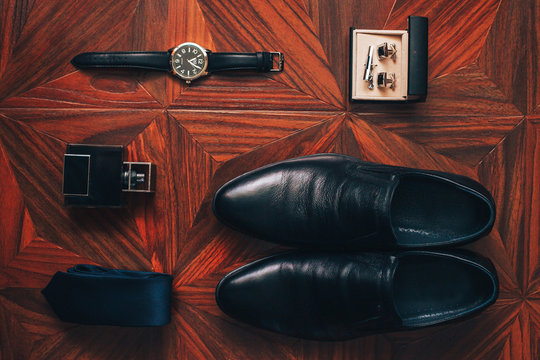 Men's accessories: watch, tie, belt, cufflinks, perfume shoes top view
