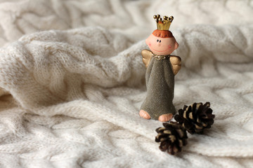 Christmas angel with cones on the wool