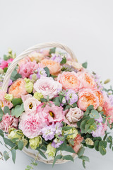 Beautiful spring bouquet in wicker basket. Arrangement with various flowers. The concept of a flower shop. A set of photos for a site or catalogue. Work florist.