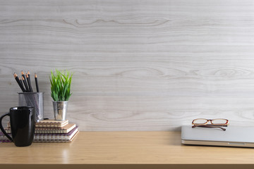 White desk table with copy space, supplies and coffee mug. Front view workspace and copy space