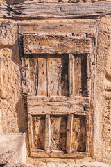 Fototapeta na wymiar Ancient wooden door in a stone house