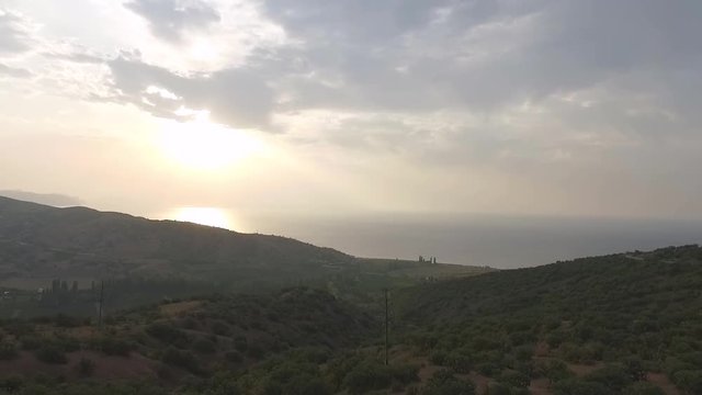 Aerial view on Athens with sea coast and sunset background. Shot. Aerial panoramic view of the Idyllic Eastern Attica near Athens - Greece. Athens seaside view vouliagmeni from above beach