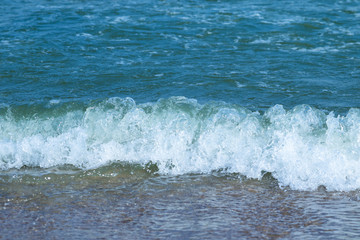 Close up view indigo sea with ripples and colorful is beautiful on the beach.