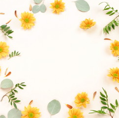 Flowers composition background. Yellow flowers frame on light background. Flat lay. top view. copy space