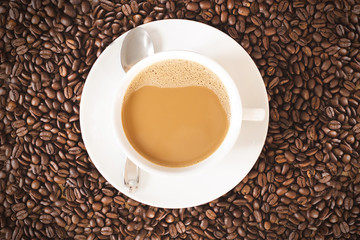 coffee in white cup with coffee beans
