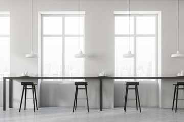White cafe interior, black stools