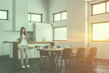 Woman in white kitchen and dining room