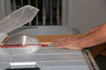 Worker laying parquet flooring. Worker installing wooden laminate flooring.