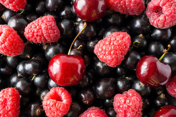 Ripe blackcurrants, cherries and raspberries. Mix berries and fruits. Top view. Background berries and fruits. 