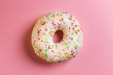 Fototapeta na wymiar Single round donut on pink background.