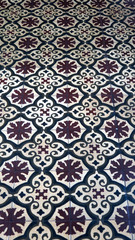 Brown and white floor tiles with floral design