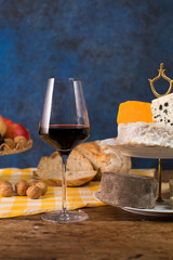 Selection of cheeses, wine and fruit.