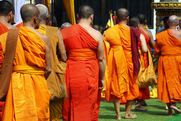 Monks recept  alms in the streets of Luang Prabang, Laos