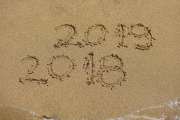 New Year 2019 concept. The inscription on the sand a number message Year 2018 replace 2019