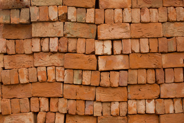 stacked red bricks with rough roughness