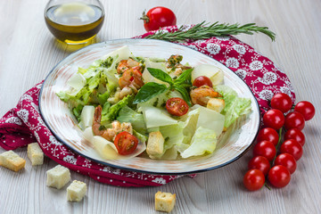 Caesar salad with seafood: Iceberg lettuce, shrimps, cherry tomatoes, parmesan cheese, crackers