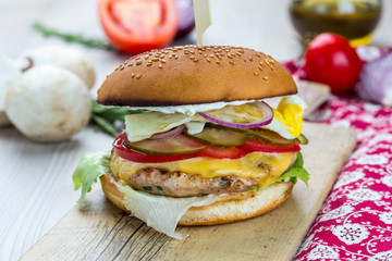 Hamburger Marbled Beef Chicken, Iceberg Salad, Cheddar Cheese, Tomatoes, Pickled Cucumbers, Onions, Barbecue Sauce