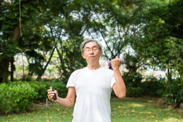 Asia senior man exercise in the park, Exercise with handgrip in the park