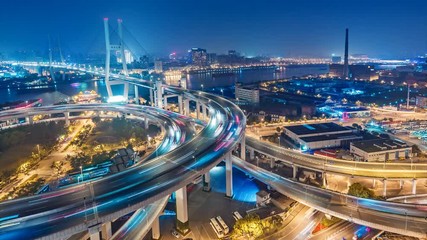 Famous highway intersection in Shanghai, China. Big modern city by night. 4K Time lapse.