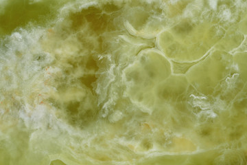 Onyx, a beautiful specimen of natural stone. Abstract drawings, divorces saturated green and white flowers on the surface of the stone. Background from a variety of agate.