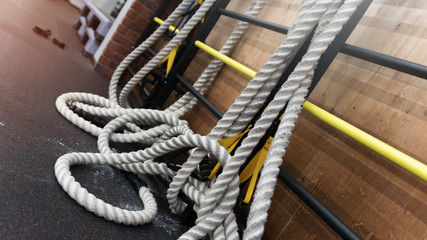 Several thick white ropes on the rubber floor