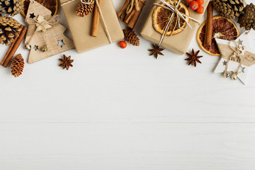 Decorative frame, christmas attributes on a white wooden table. Place for text, blank for postcard. Copy space.