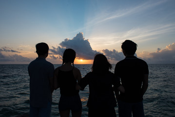 Family Watching Sunset by the Sea
