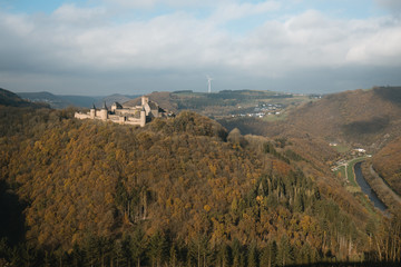Fototapeta na wymiar Bourscheid castle with autumn colors, cloudy day