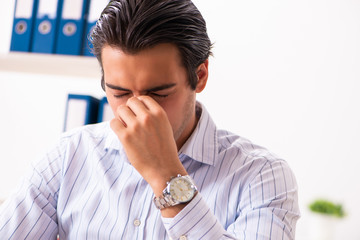 Young employee sitting at the office 