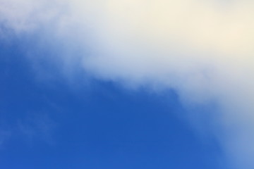 Bright blue sky with white fluffy beautiful cloud formation on sunny day for design background and wallpaper