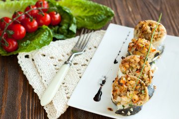 White fish rolls stuffed with crab meat and onions