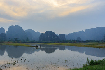 rice fields with the karst mountains in ninh binh, vietnam