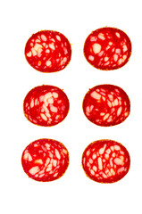 Six round pieces of smoked sausage isolated on white background.