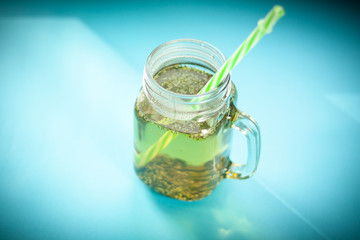 green herbs tea, on a blue background, the light from the window