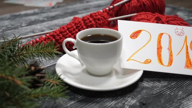 New Year 2019 concept. A cup of coffee and a 2019 note placed on a wooden background together with red yarn with knitting needle and pine tree branches. hd