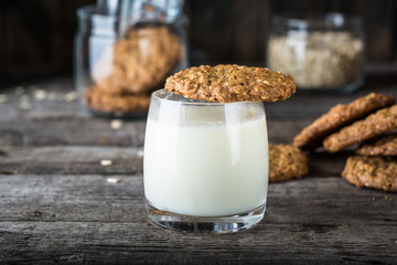 Homemade oatmeal cookies on wooden board on old table background. Healthy Food Snack Concept. Copy space. Milk and cookies. Still life of food. Christmas cookies. Healthy food. Breakfast concept.