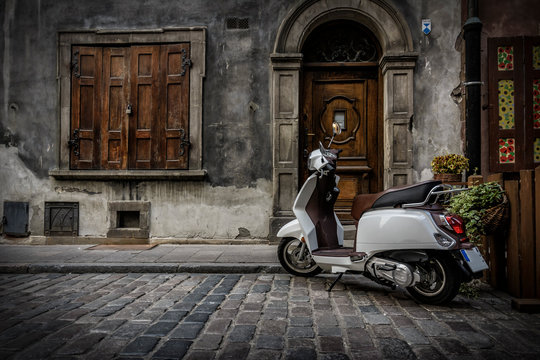 New Vespa Scooter Parked In The Italian Street Court - Vacanze Romane