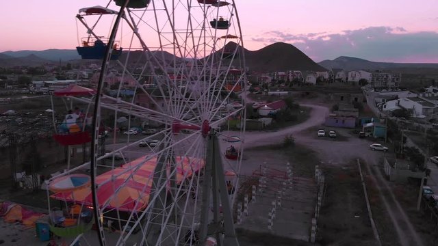 Ferris Wheel on the Background of the Sea at sunset. View from above