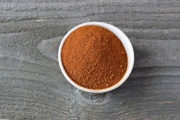 Cinnamon powder on wooden background