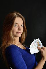 Young woman holding poker cards