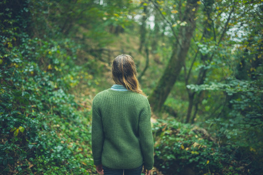 Young woman walking in the woods