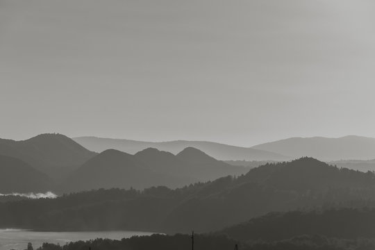 Fototapeta Ridges of the mountains at sunrise. Black and white.