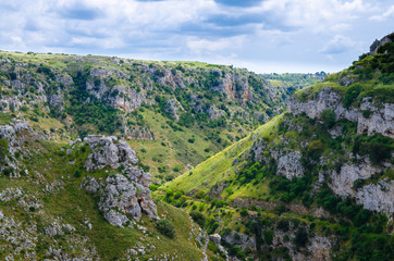 Fototapeta na wymiar View of canyon with rocks and caves Murgia Timone, Matera Sassi, Italy